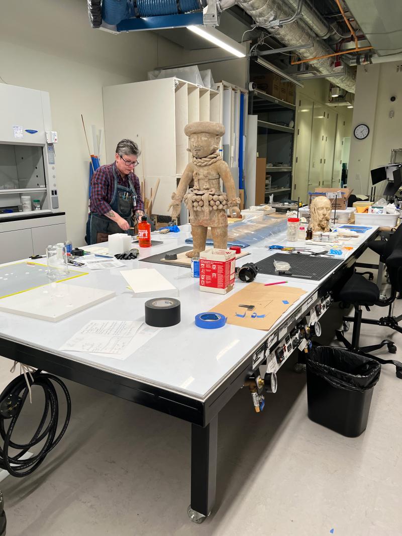 Conservator working with a sculpture